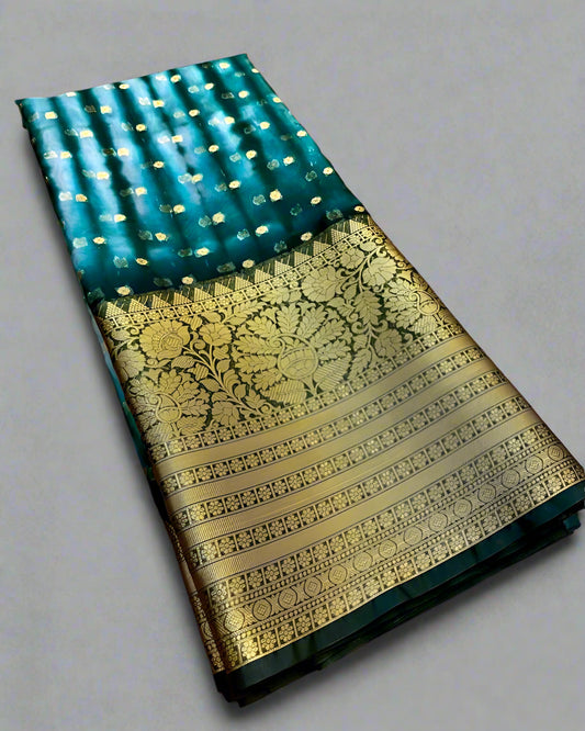 Traditional saree with green and gold pattern on a gray background