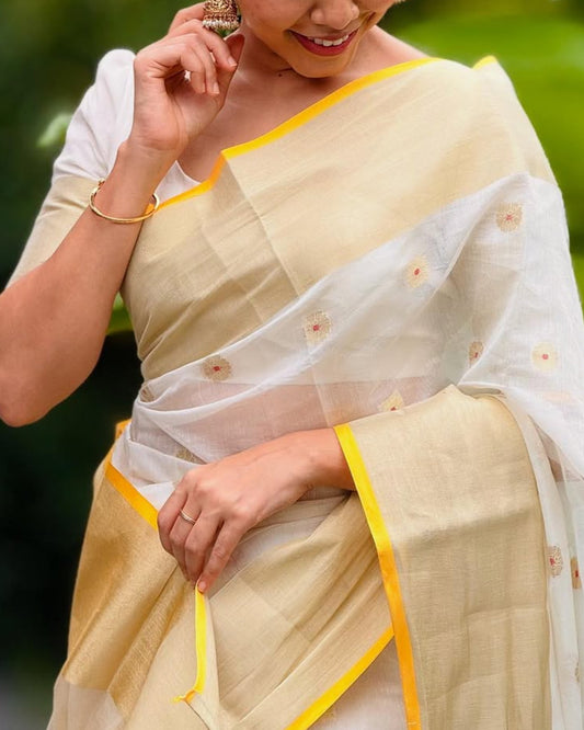 Woman in a traditional saree with green foliage in the background