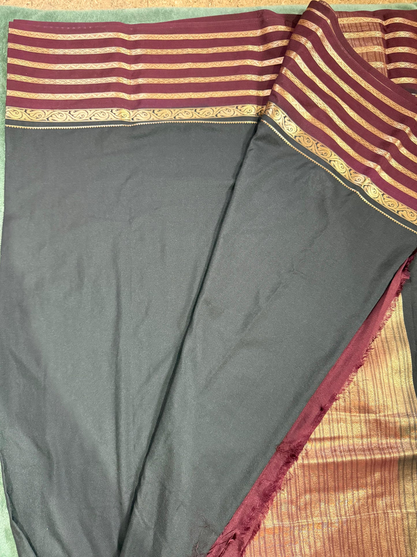 black saree with maroon and gold border