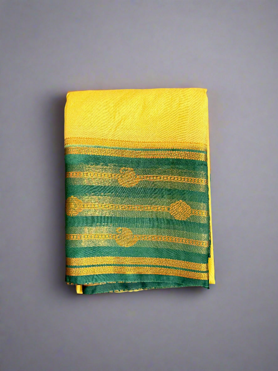 Yellow and green saree with gold patterns on a gray background