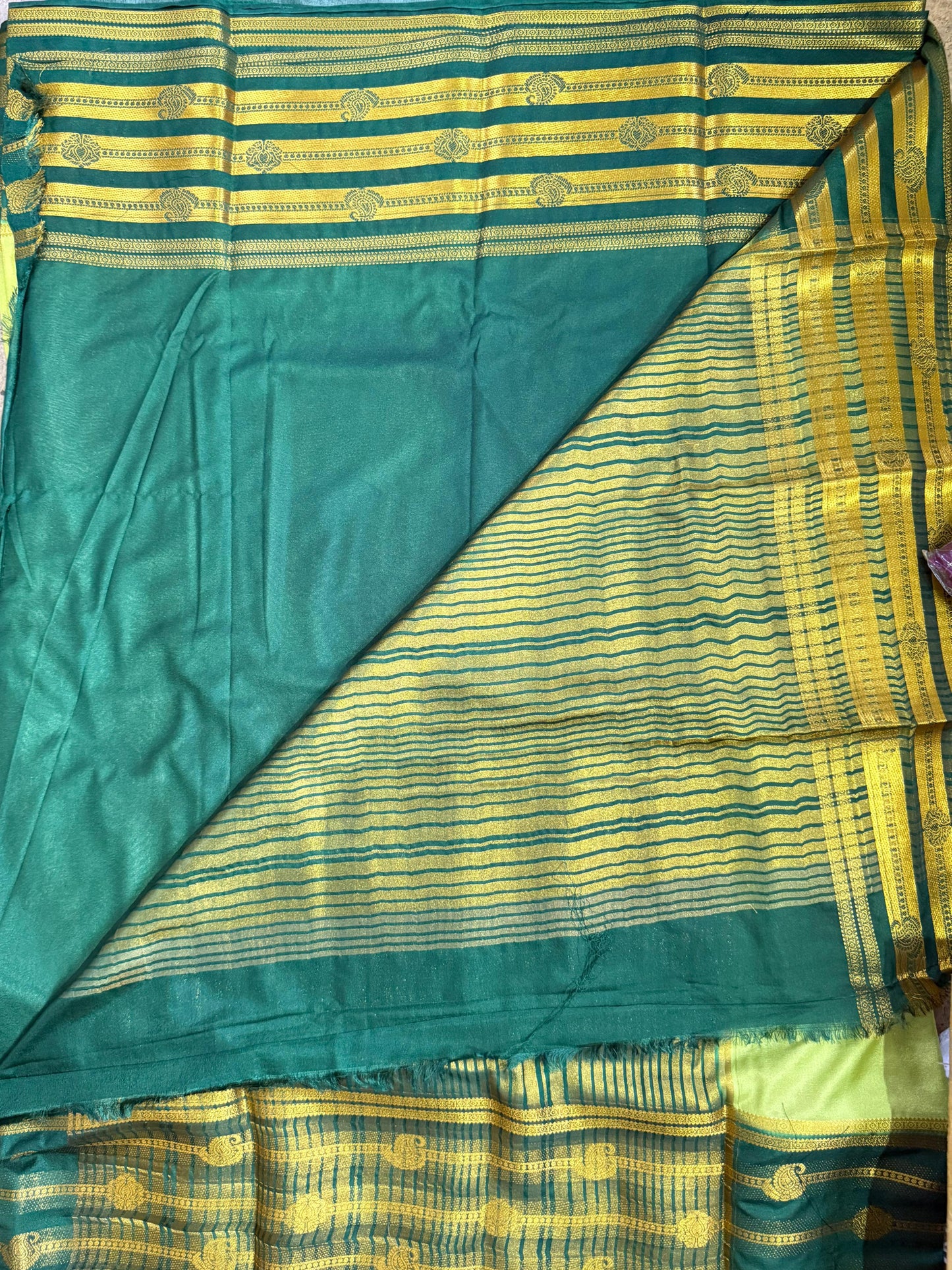 Green and yellow striped fabric with a pattern on a plain background