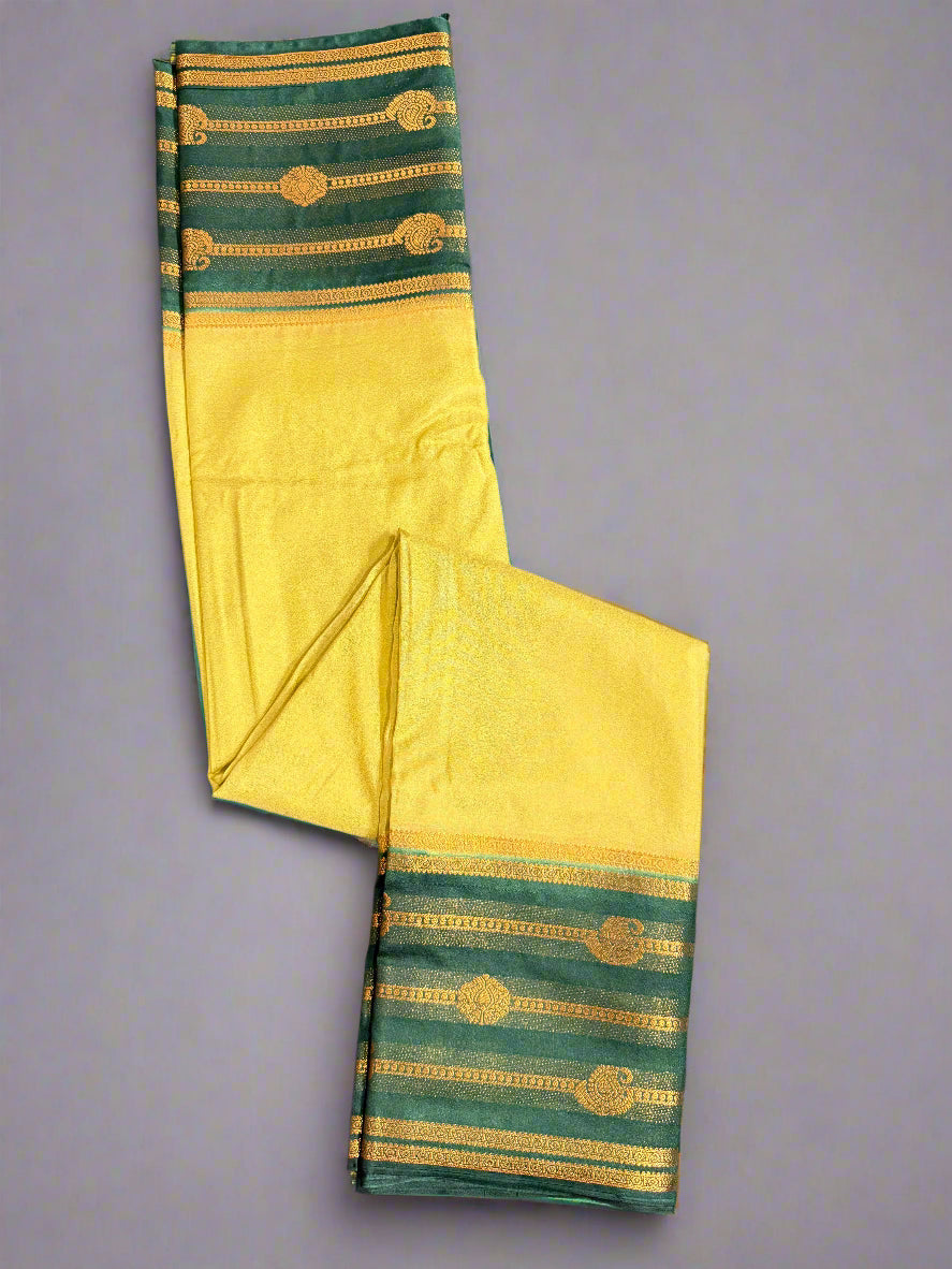 Yellow and green traditional fabric with gold patterns on a gray background