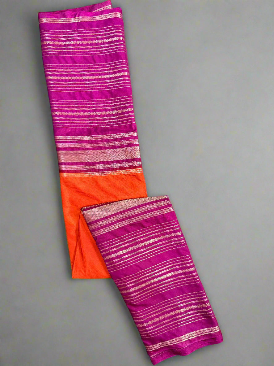 Folded fabric with pink and orange stripes on a textured gray background