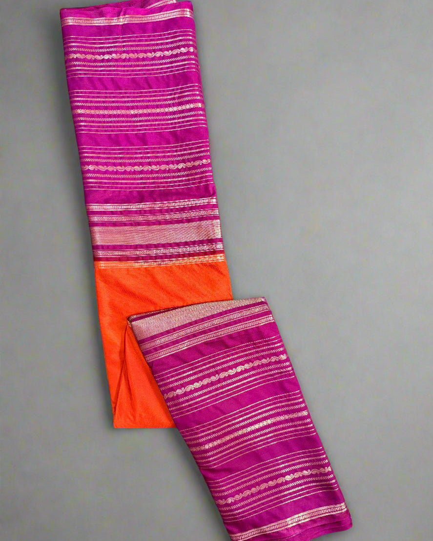Folded fabric with pink and orange stripes on a textured gray background