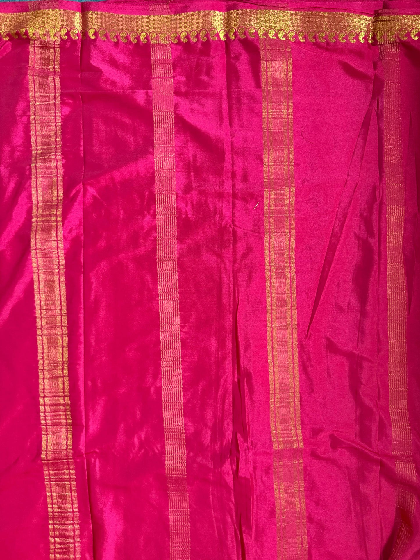 Pink fabric with gold stripes and border
