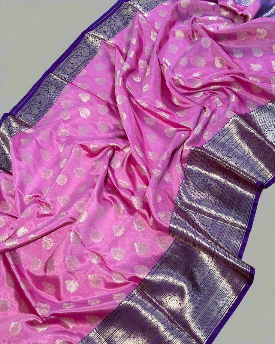 Pink saree with silver border on a white floor