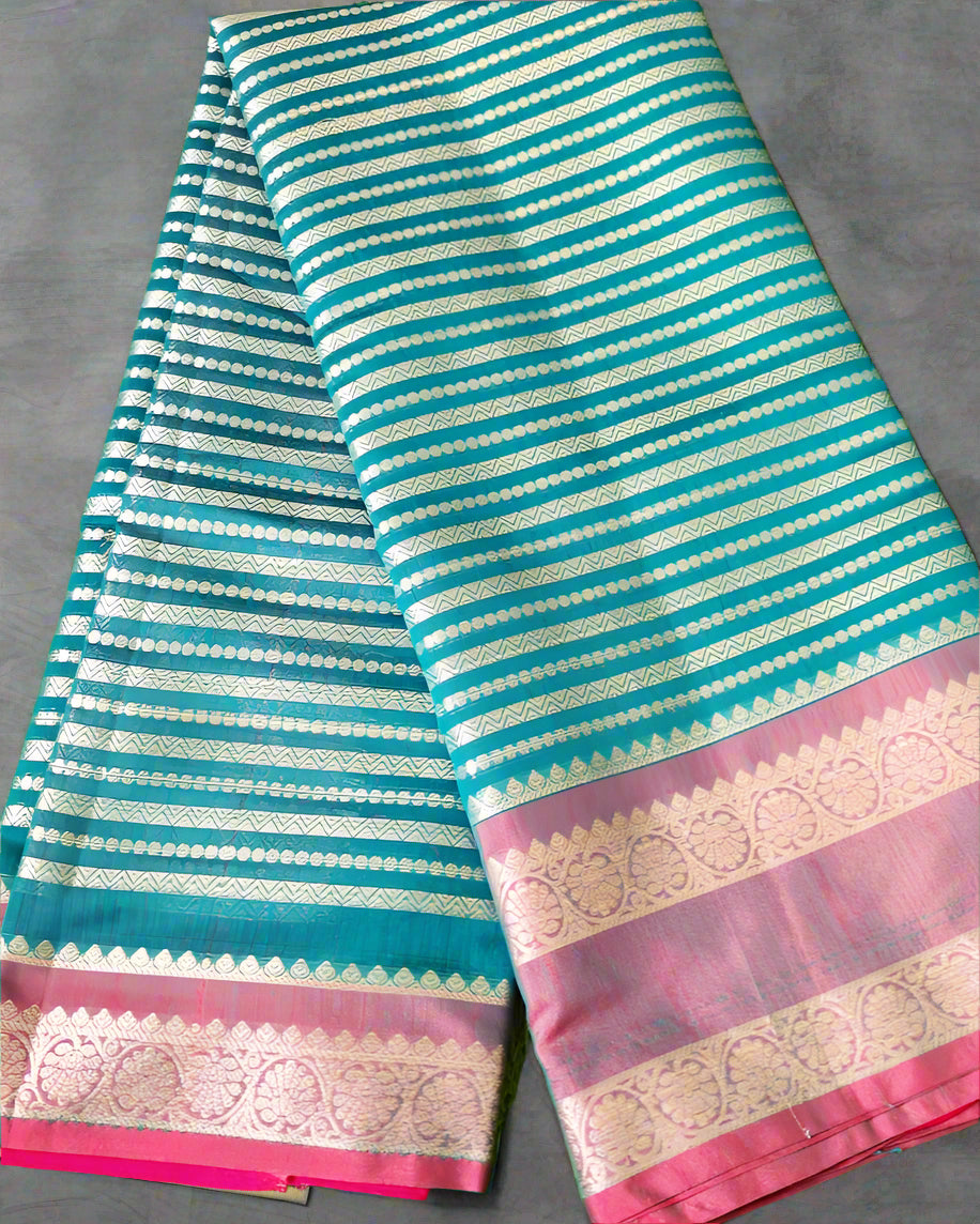 Striped fabric with pink and gold border on a grass background