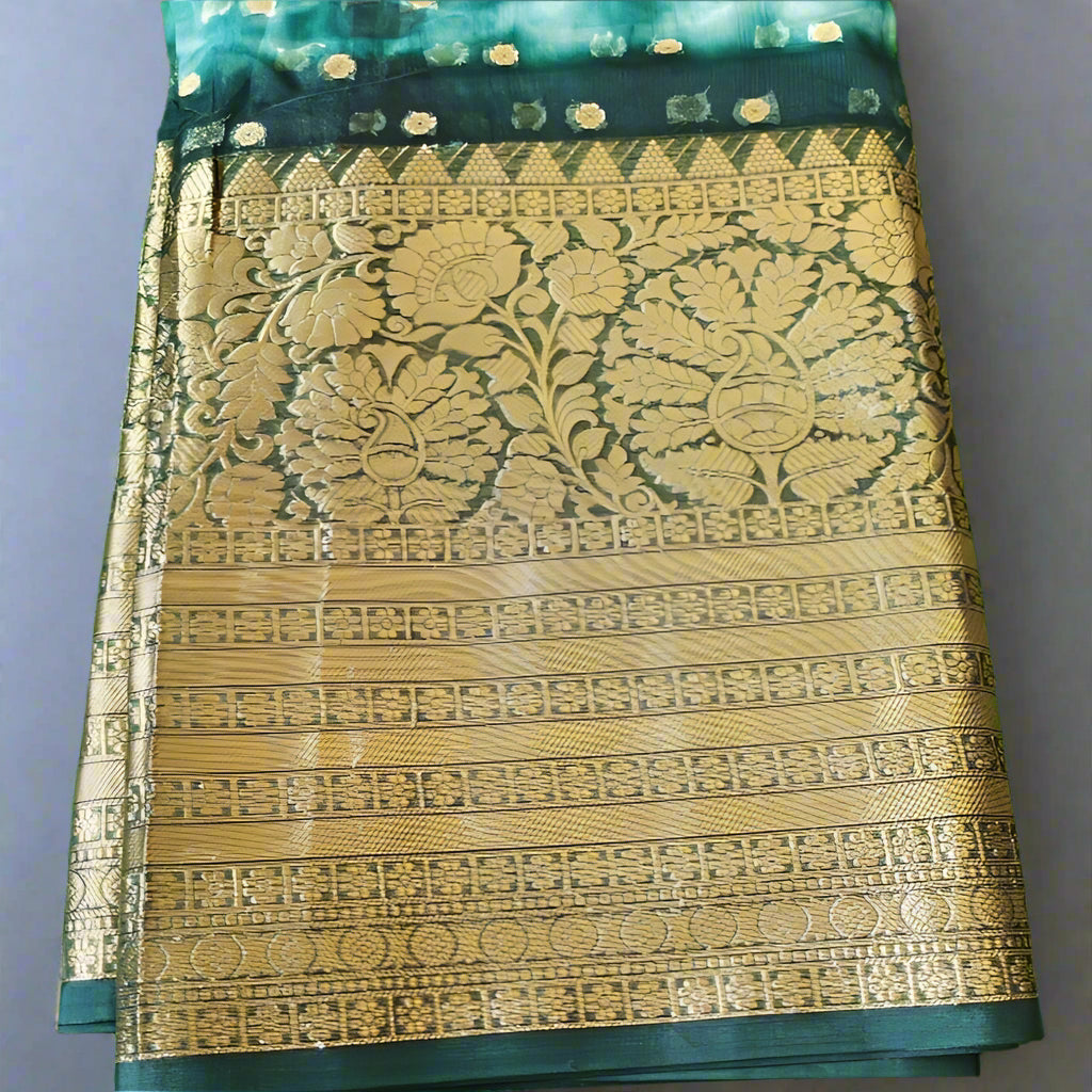A Handwoven Banarasi Organza Saree with intricate gold and silver Zari weave patterns on a dark base