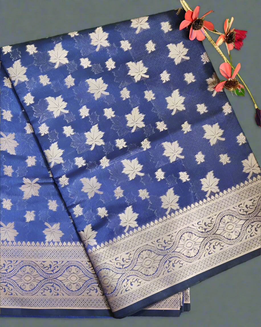 Blue saree with white floral patterns on a gray background