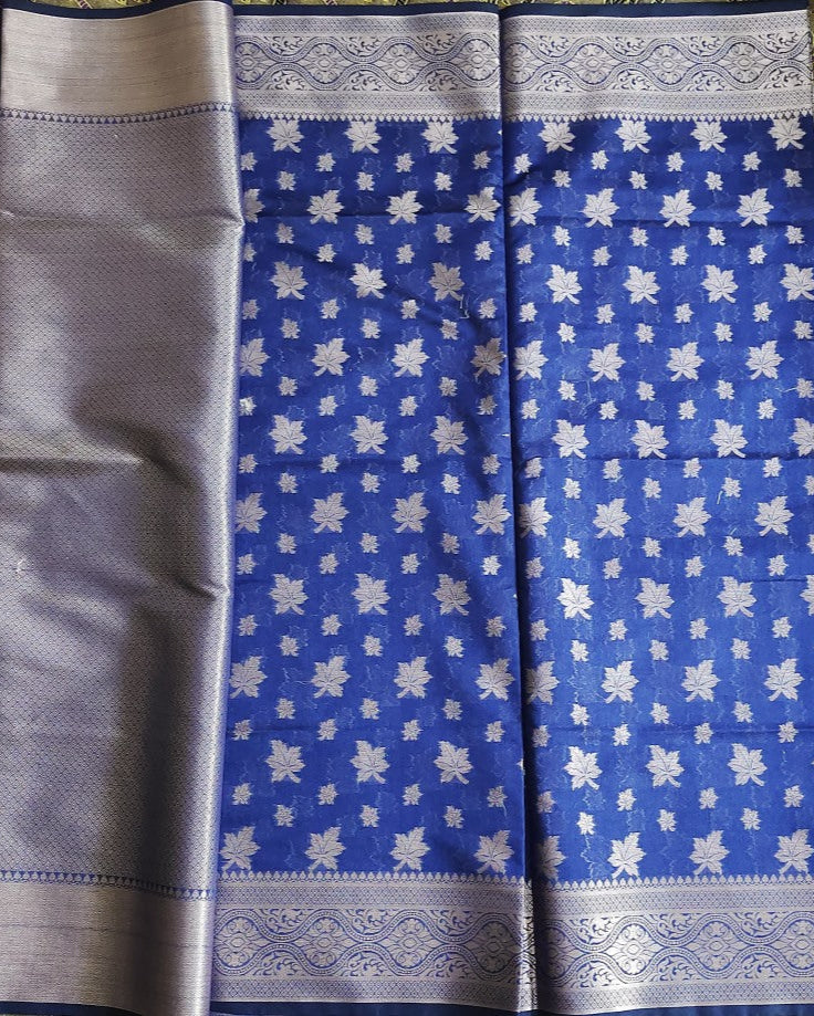 Blue saree with white floral patterns and silver border