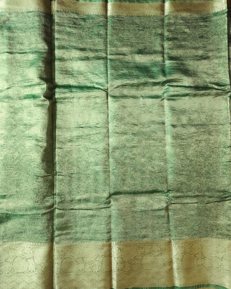 Green fabric with a subtle pattern and gold border