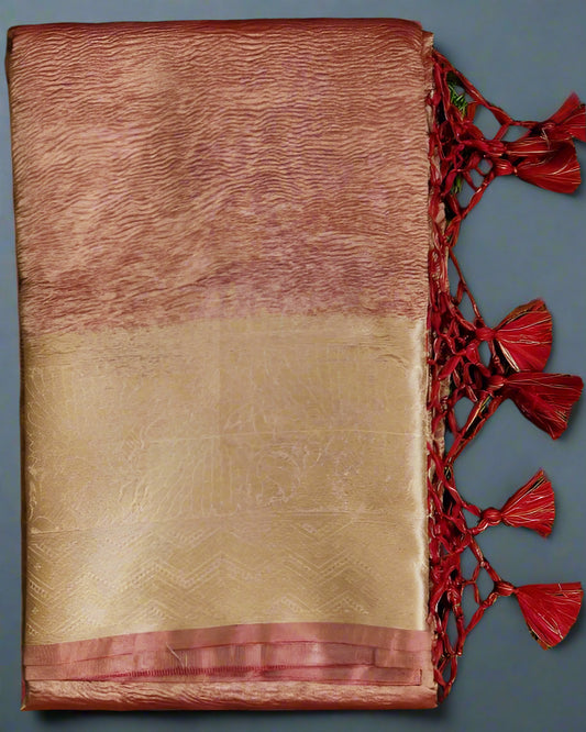 A folded maroon and beige banarasi handwoven crush tissue silk saree with zari weave pallu and blouse, displayed on a green background.