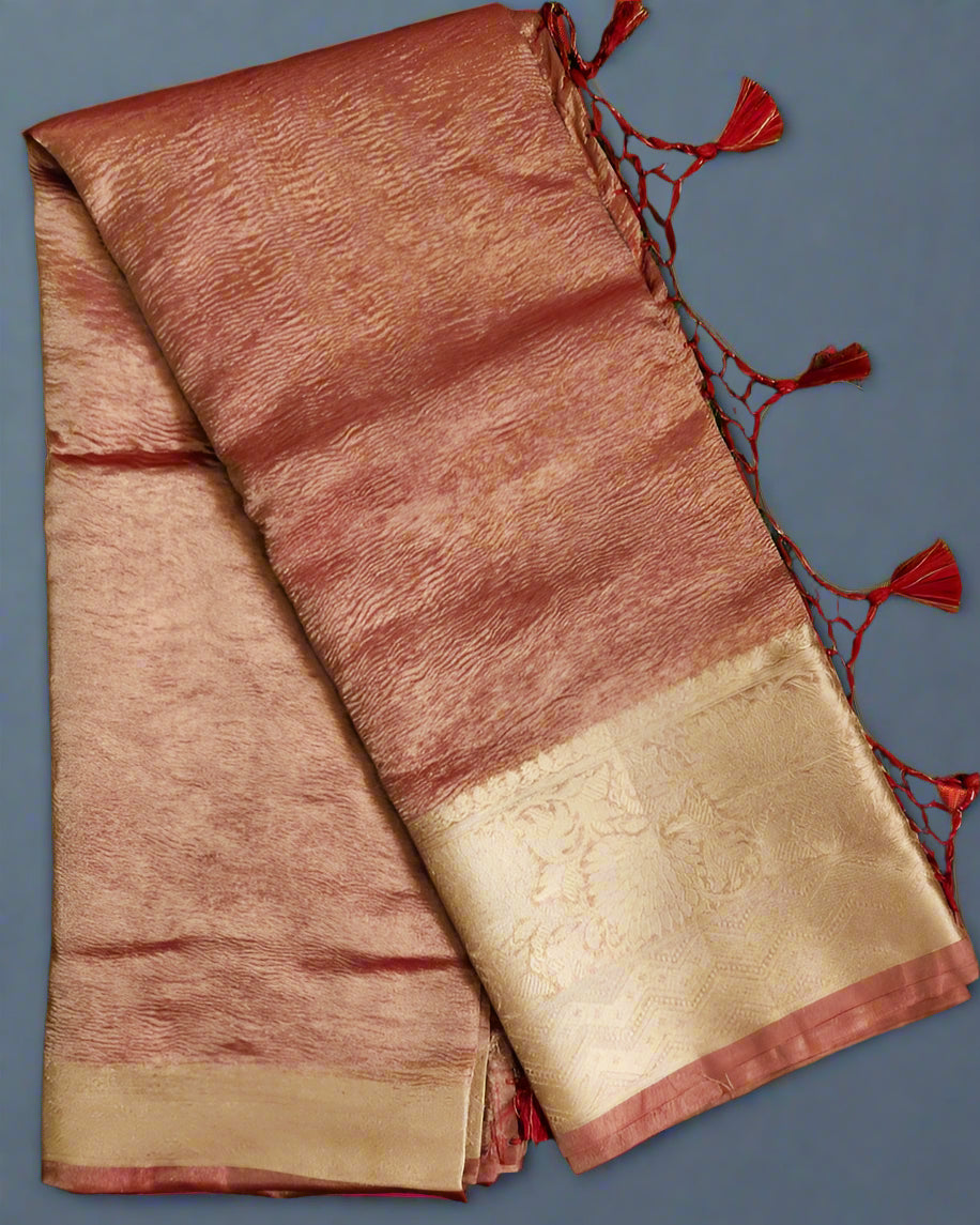 Folded fabric with red and gold colors on a gray background