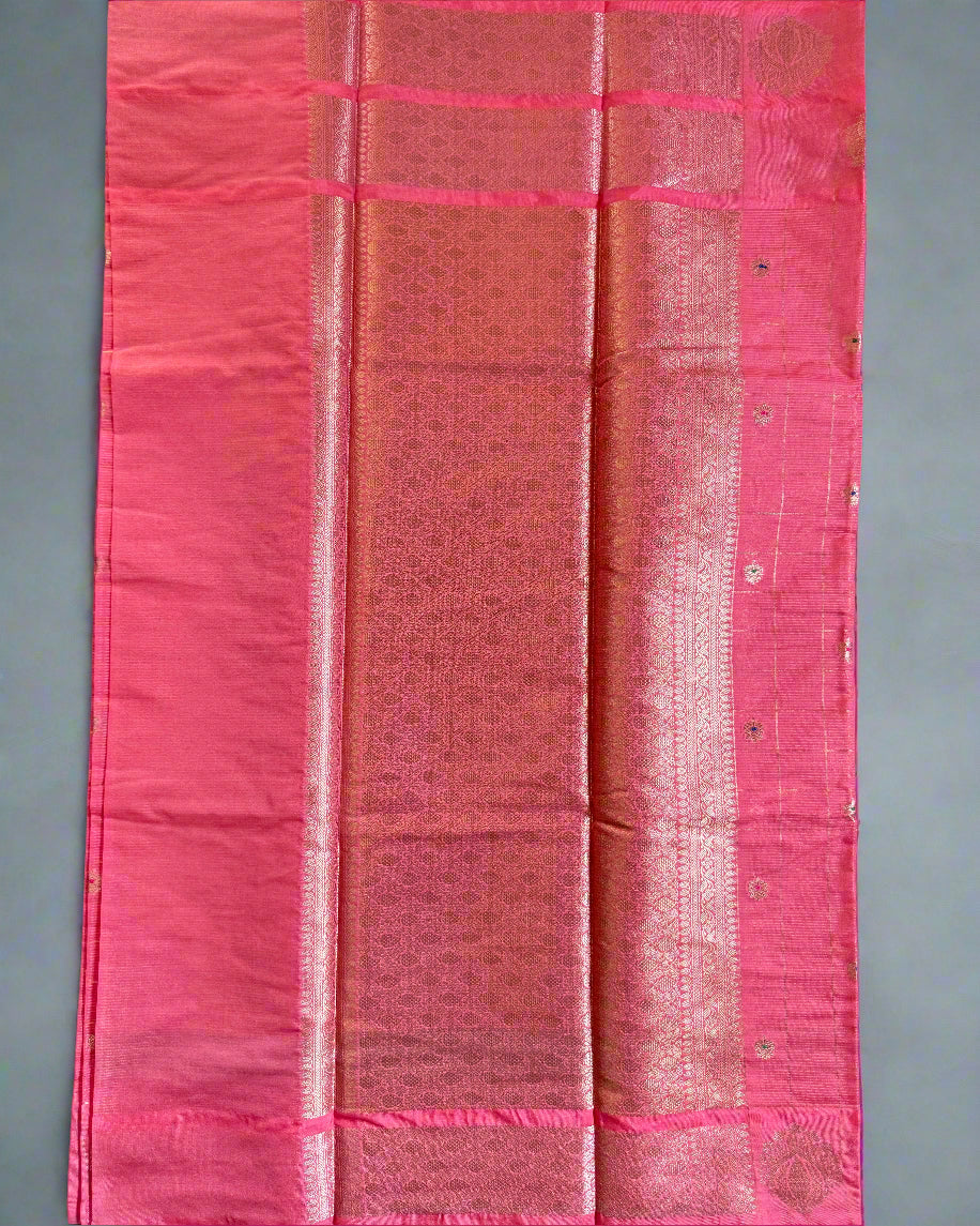 Pink fabric with a subtle pattern on a dark background