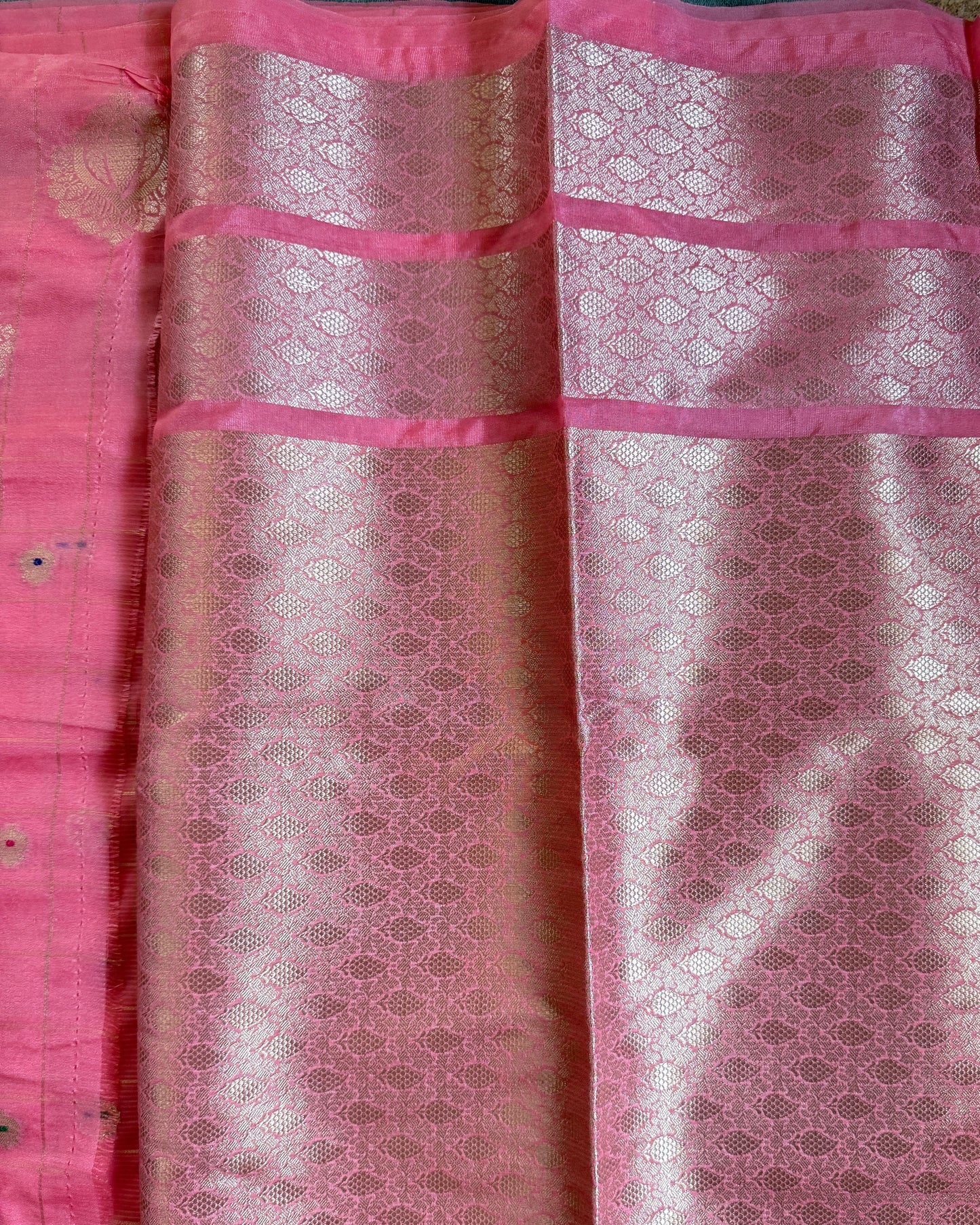 Pink fabric with a subtle pattern on a plain background