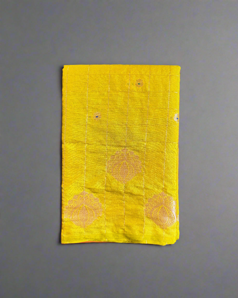 Yellow fabric with floral patterns on a textured gray surface