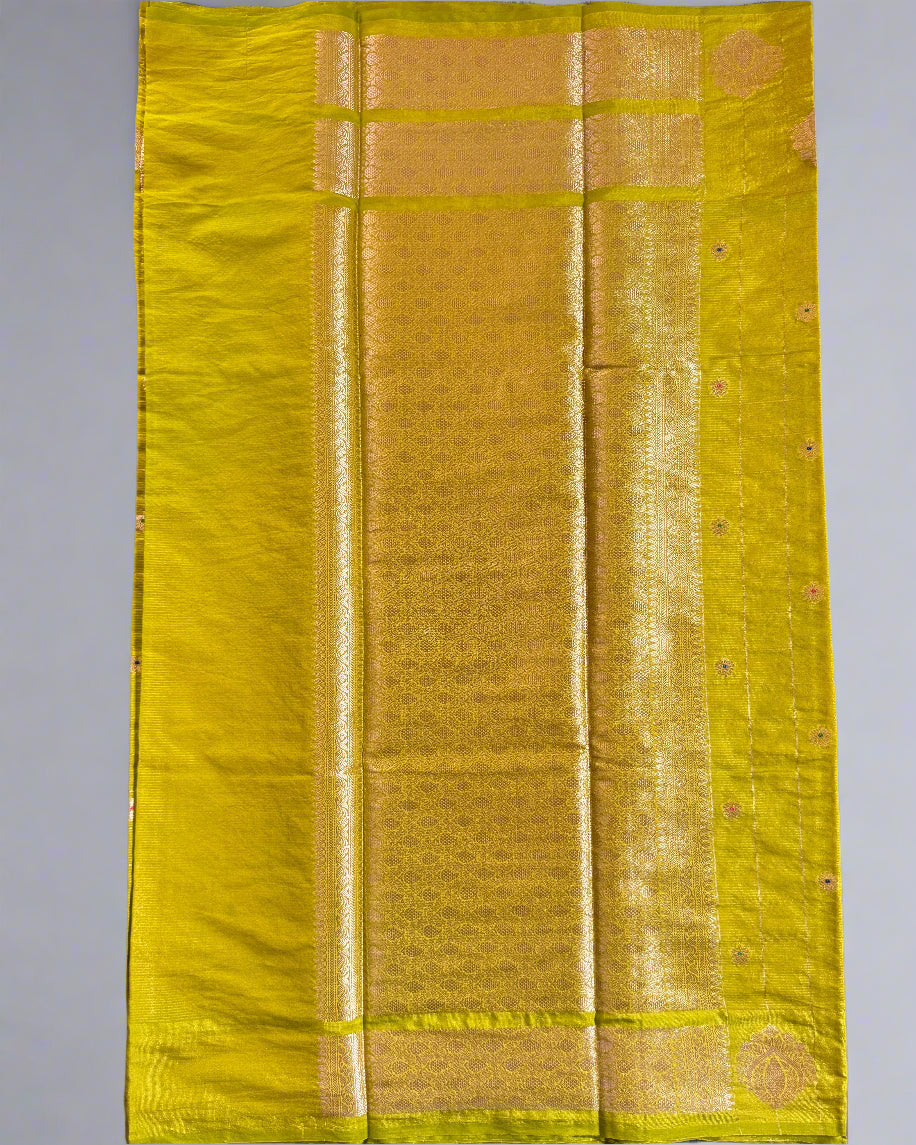 Yellow fabric roll on a gray surface with a black sandal partially visible.