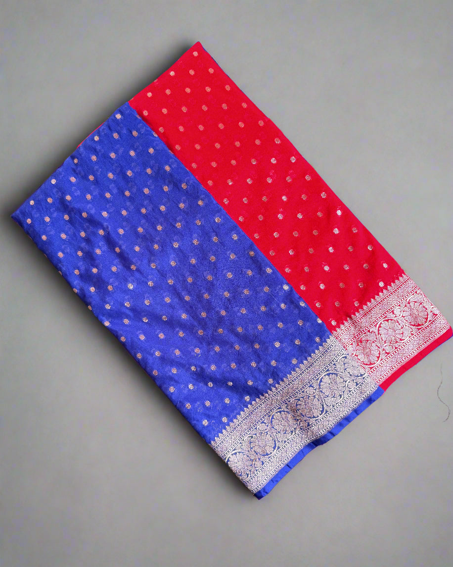 Red and blue fabric with a patterned border on a gray surface