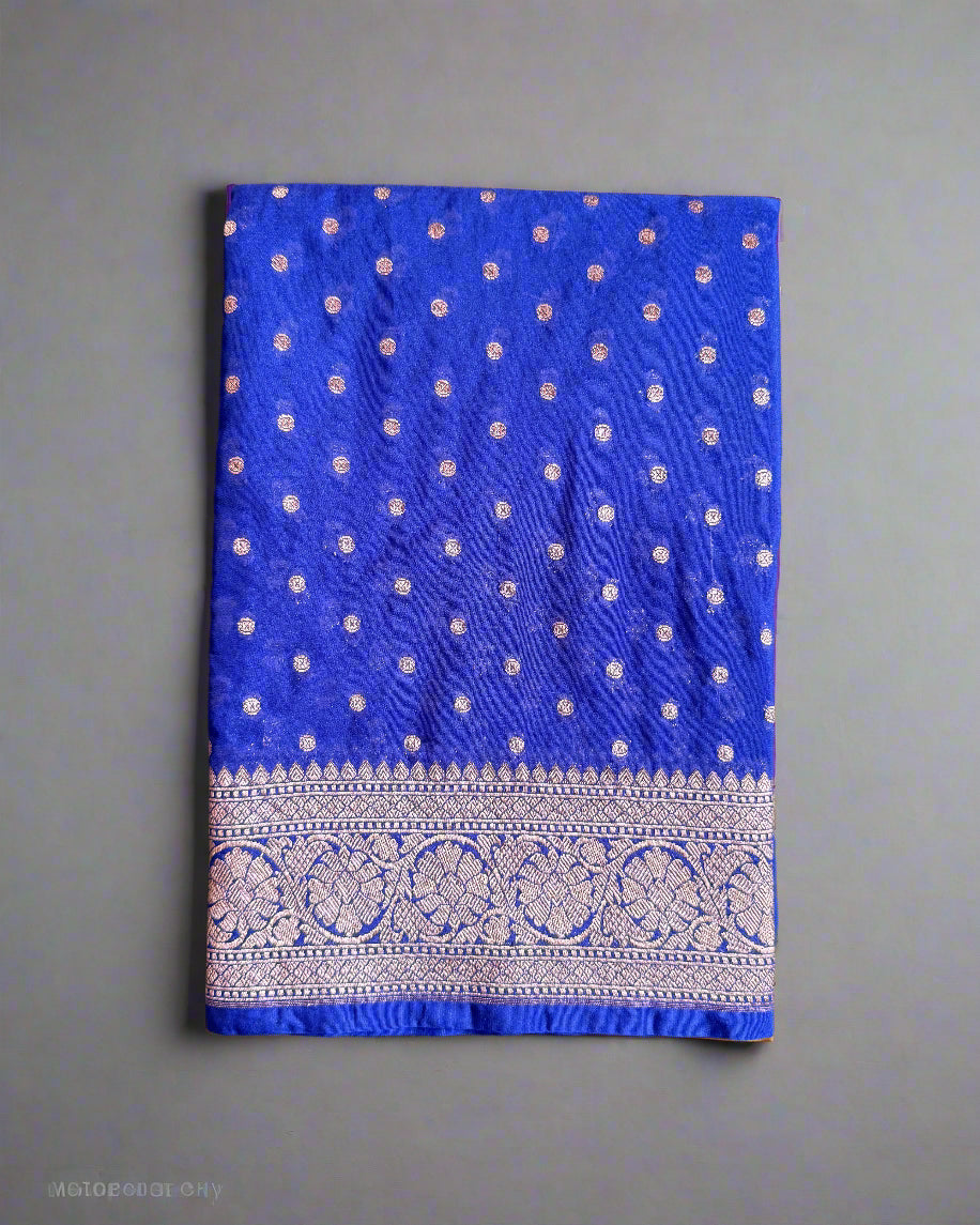 Blue fabric with white patterns and a decorative border on a gray background