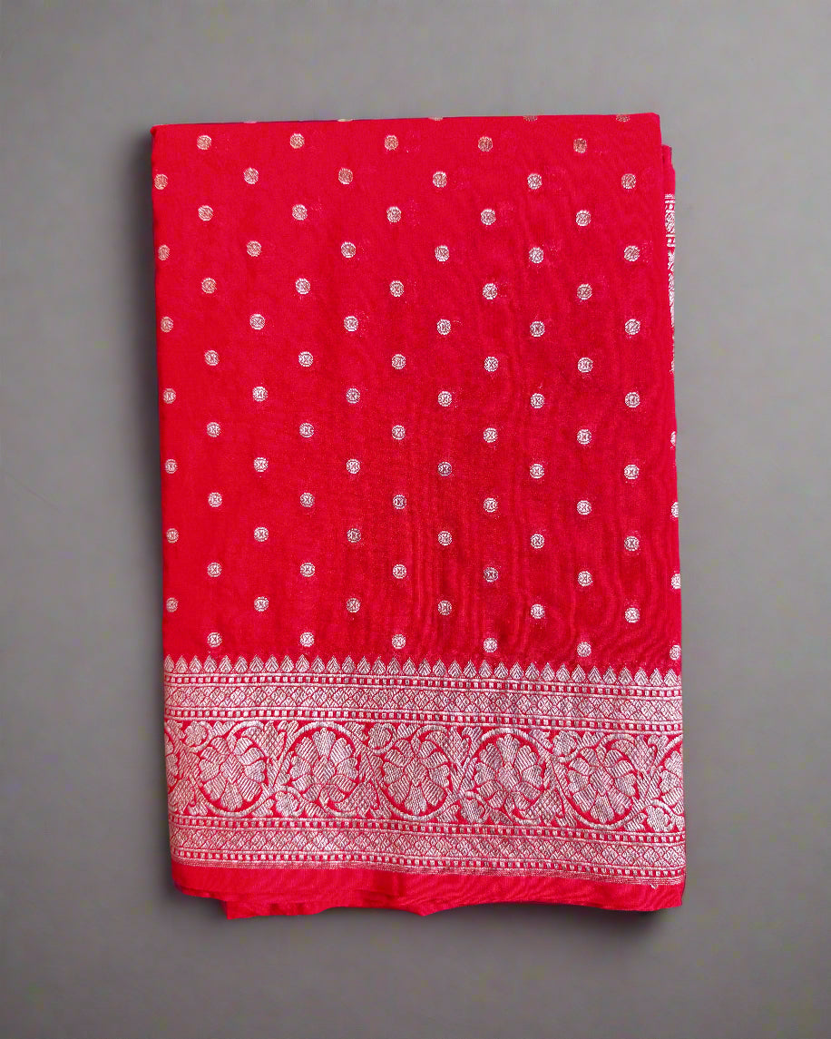 Red fabric with white patterns on a gray surface