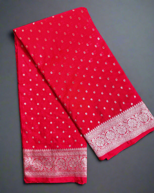 Red fabric with white patterns on a gray surface