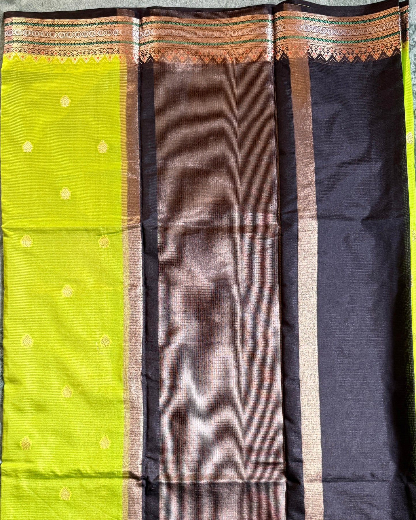 Sari with a black, brown, and green pattern on a gray background