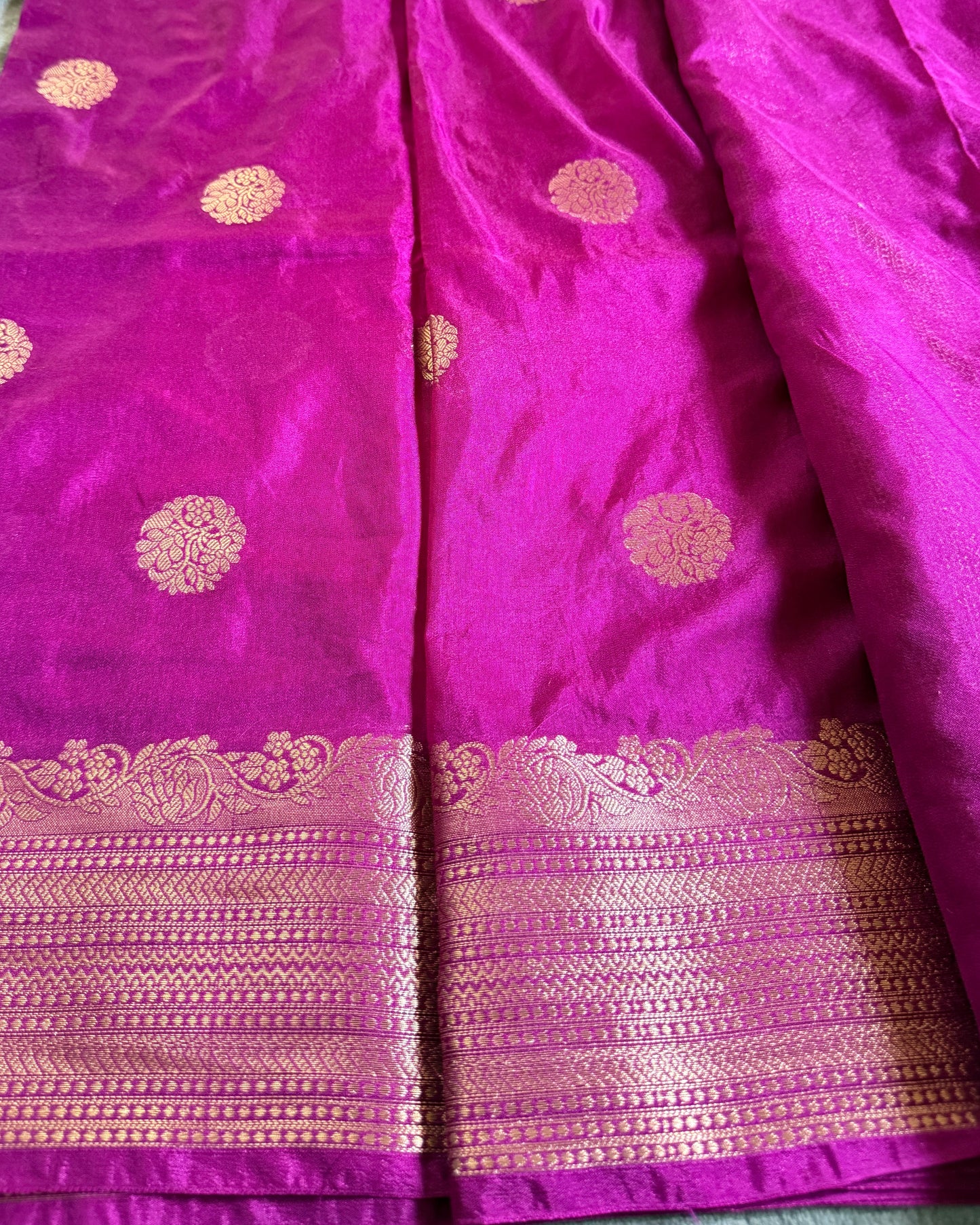 Purple fabric with gold patterns and border