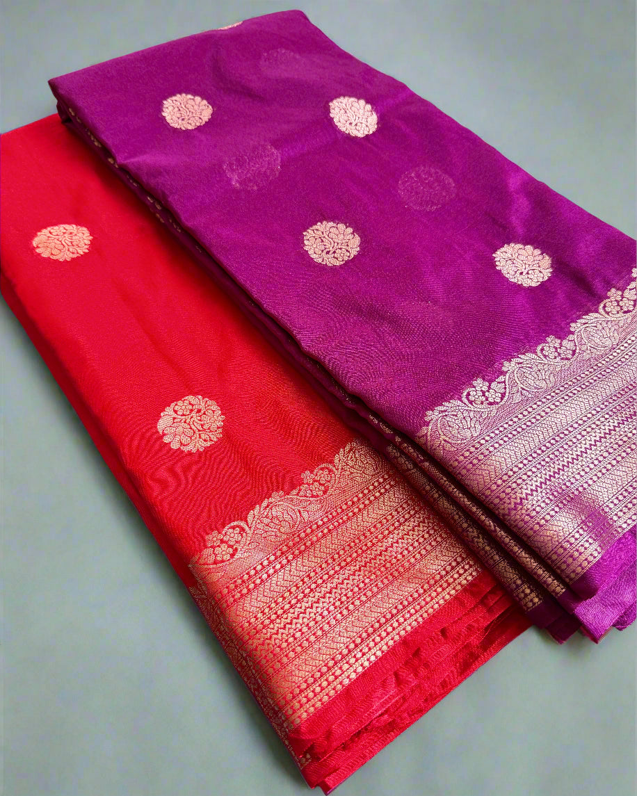 Purple and red sarees with gold patterns on a gray surface
