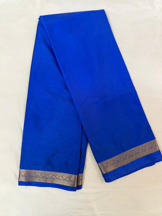 Blue saree with a gold border on a white background