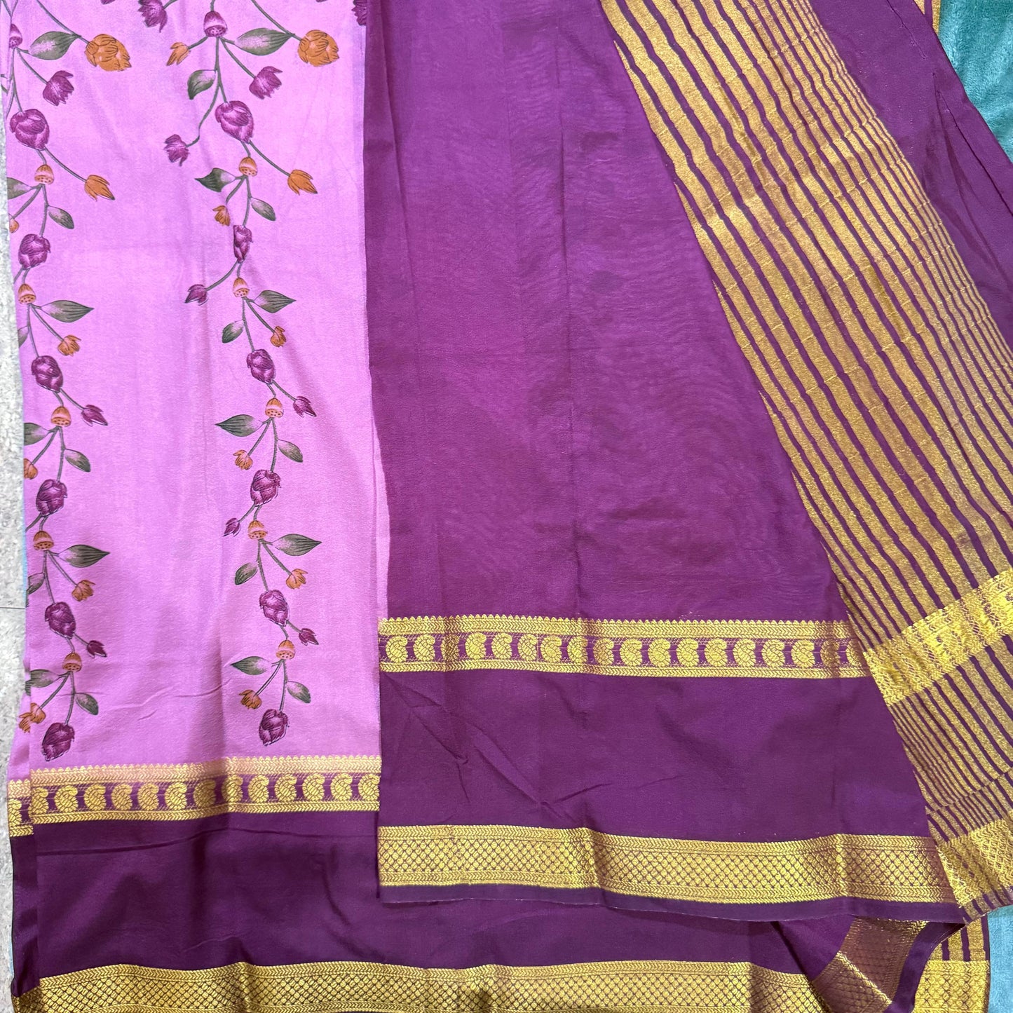 Purple fabric with gold border and floral design on a pink background