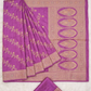 Purple saree with gold embroidery on a light gray background