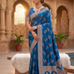 Woman in a blue saree standing in an ornate architectural setting