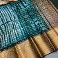 Teal and gold saree with a pattern 