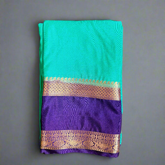 Teal and purple fabric with gold border on a gray background