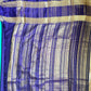 Blue and gold striped fabric on a plain background