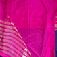 Pink and purple saree with a visible border on a flat surface
