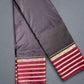 black saree with gold and red border on a textured surface