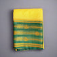Yellow and green saree with gold patterns on a gray background