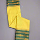 Yellow and green traditional fabric with gold patterns on a gray background
