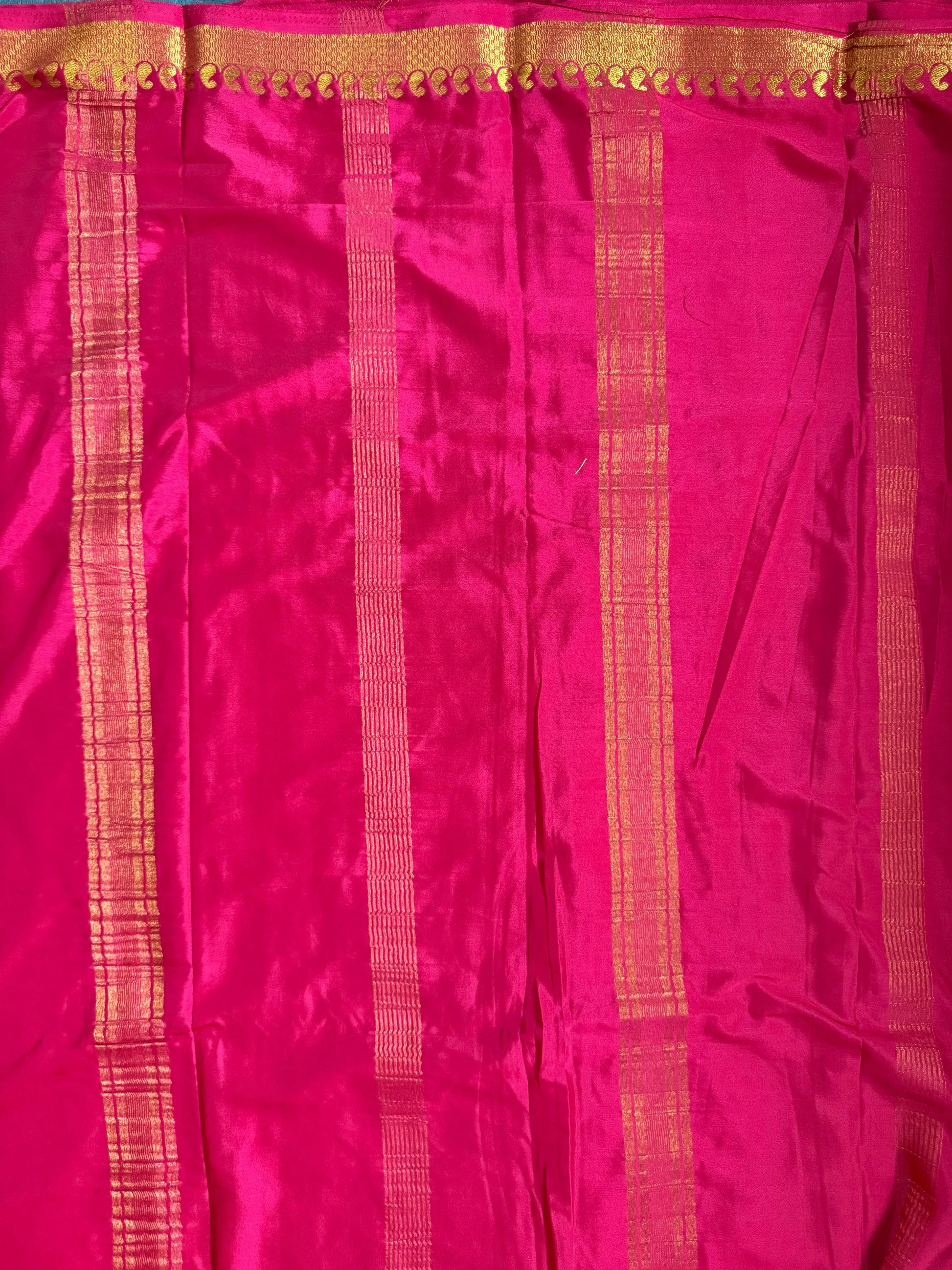 Pink fabric with gold stripes and border