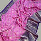 Pink saree with silver border on a white floor