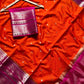 Red saree with pink border on a marble surface