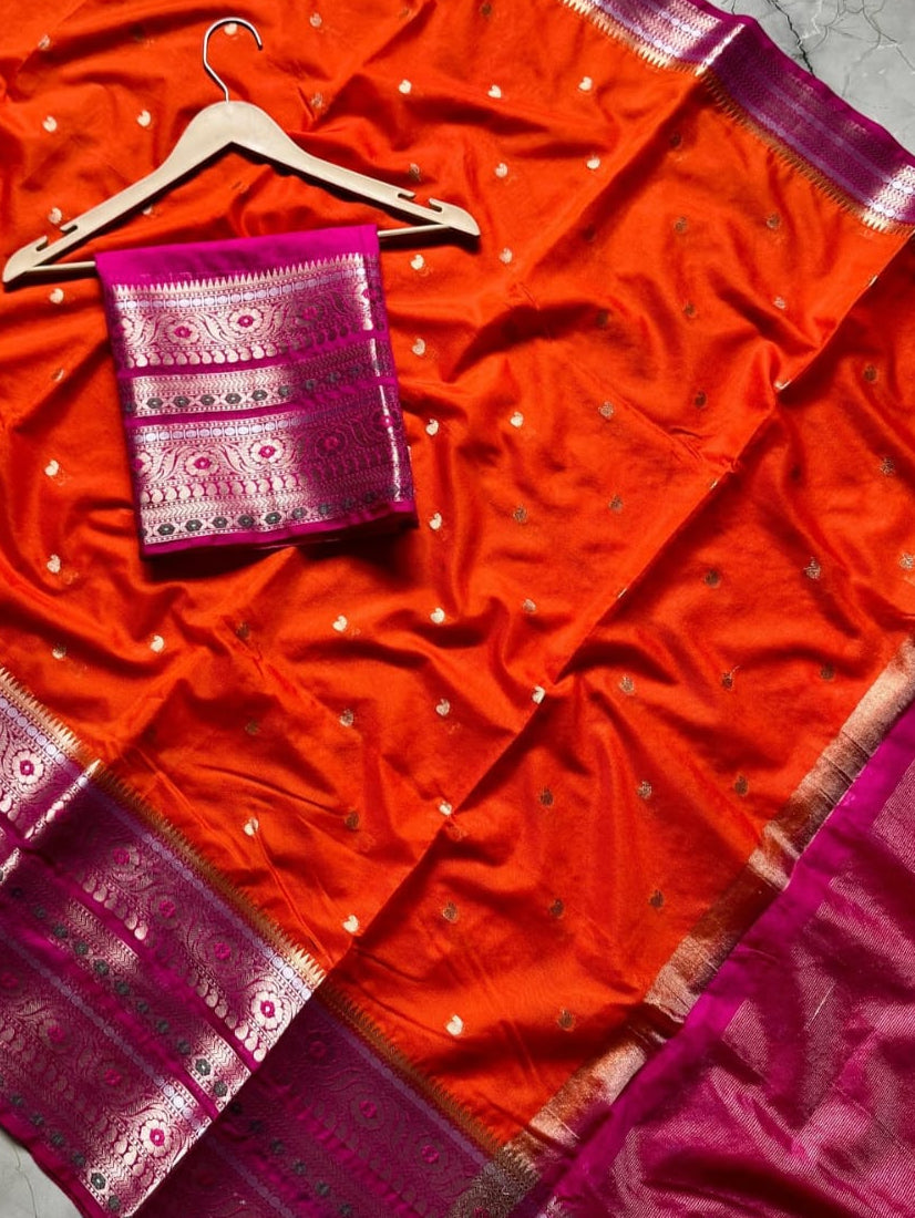 Red saree with pink border on a marble surface