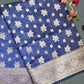Blue saree with white floral patterns on a gray background