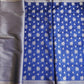 Blue saree with white floral patterns and silver border