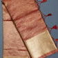 Folded fabric with red and gold colors on a gray background