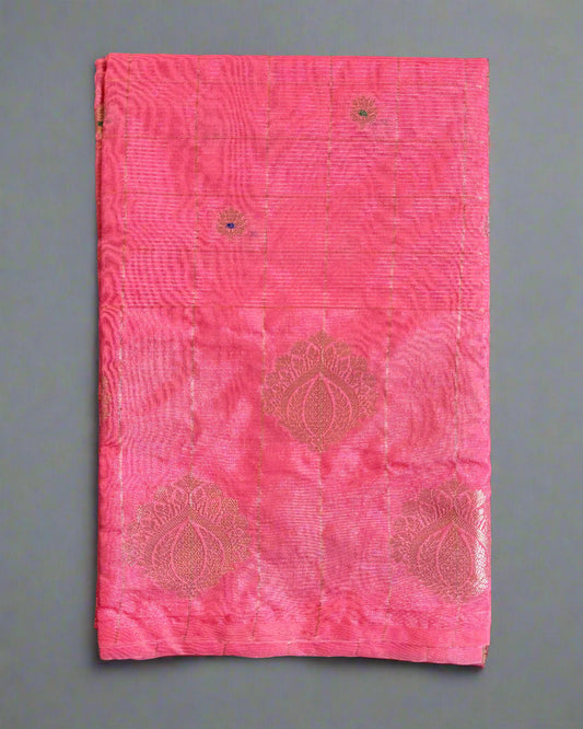 Pink fabric with embroidered patterns on a gray background