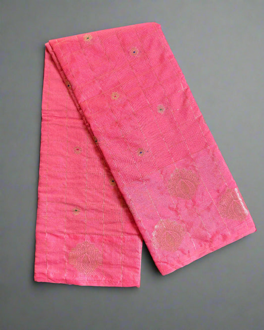 Pink fabric with floral patterns on a gray textured surface