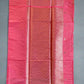 Pink fabric with a subtle pattern on a dark background