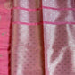 Pink fabric with a subtle pattern on a plain background